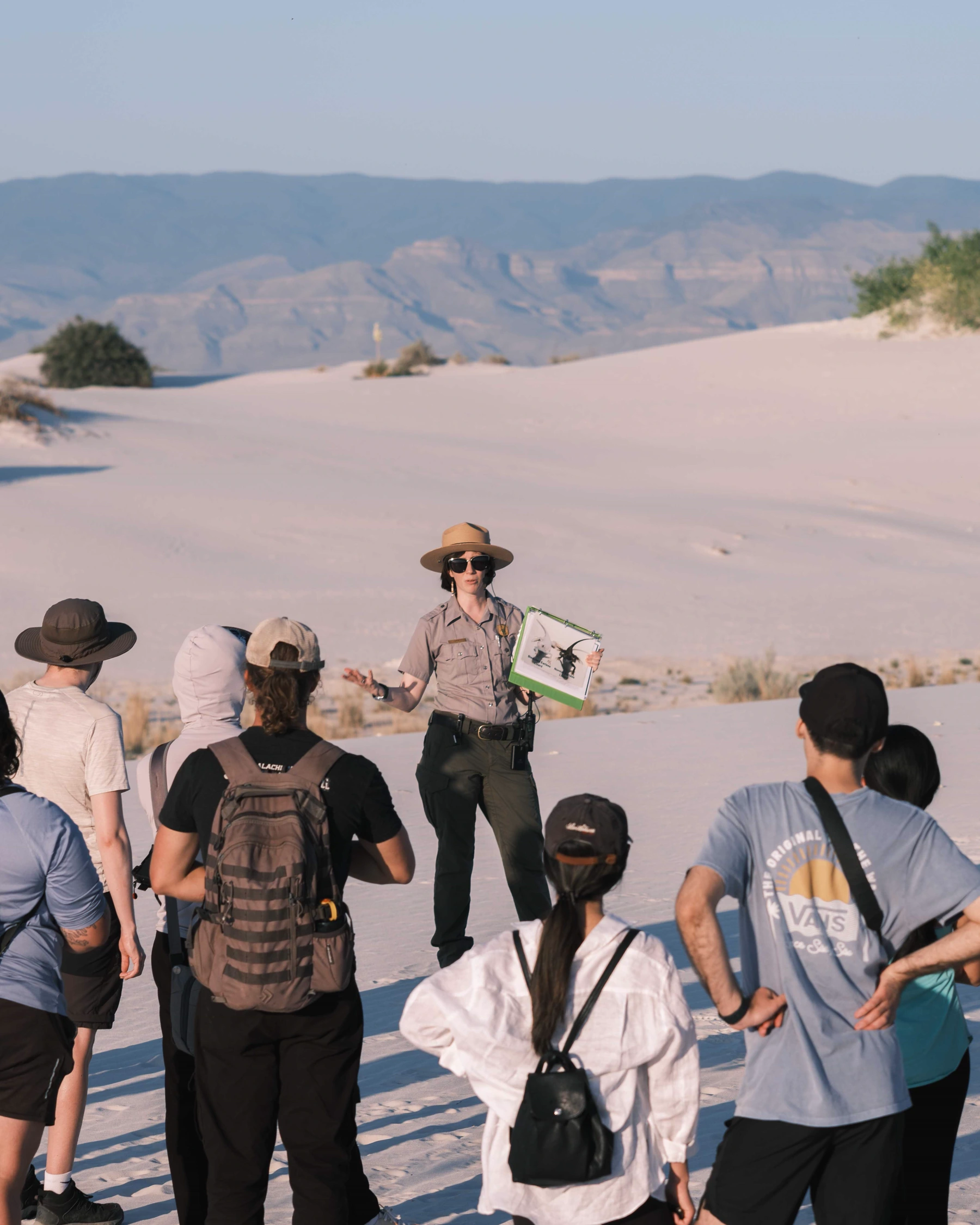 A local tour guide welcoming a small group of international travelers on a pedestrian street